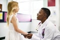 Friendly pediatrician talking to her little patient Royalty Free Stock Photo
