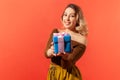 Friendly positive woman holding blue gift with pink ribbon, preparing present for you, looking at camera with smile Royalty Free Stock Photo