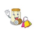 A friendly rich coconut butter waving and holding Shopping bag