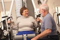 Friendly Senior Adult Couple Working Out Together in the Gym Royalty Free Stock Photo