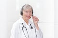 Friendly senior doctor headset microphone Royalty Free Stock Photo