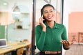 Friendly smiling african-american female employee has pleasant phone conversation