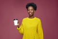 Friendly smiling african american woman hold takeaway coffee cup recommend coffee shop, enjoy hot drink from cafe Royalty Free Stock Photo