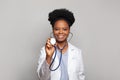 Friendly smiling confident female healthcare professional. Doctor woman in labcoat holding stethoscope on white background Royalty Free Stock Photo