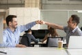 Friendly smiling male colleagues fist bumping celebrating good t Royalty Free Stock Photo