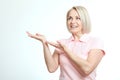 Friendly smiling middle aged woman pointing at copyspace isolated Royalty Free Stock Photo