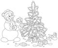 Funny snowman decorating a Christmas tree