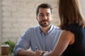 Friendly smiling teammates discussing project ideas at office. Royalty Free Stock Photo