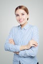 Friendly smiling woman with crossed arms. Student and businesswoman in blue and white striped shirt portrait Royalty Free Stock Photo