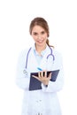 Friendly smiling young female doctor filling up medical history form, over white background Royalty Free Stock Photo