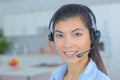 Friendly smiling young woman phone operator at workplace Royalty Free Stock Photo