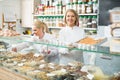 Friendly staff offering sweets in confectionery Royalty Free Stock Photo