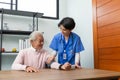 Friendly staff and senior man is checking  with blood pressure and heart rate with digital pressure gauge by herself at home. Royalty Free Stock Photo