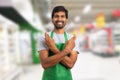 Supermarket worker making good luck gesture