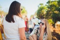 Friendly talk. Two beautiful young women walking along the street and talking. Royalty Free Stock Photo