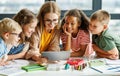 friendly Teacher and students watching video together