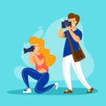 Friendly team of photographers works together. Young man and woman taking photo with digital cameras. Royalty Free Stock Photo