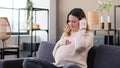 Friendly Woman Expecting Childbirth And Resting On Sofa At Home