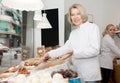 Friendly women offering sweets in confectionery Royalty Free Stock Photo