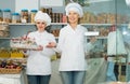 Friendly women staff offering sweets Royalty Free Stock Photo