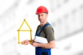 Friendly worker with yardstick- house and blueprint