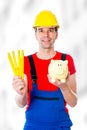 Friendly worker with yardstick and piggy bank