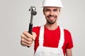 Friendly workman with hammer looking at camera