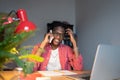 Friendly young African man freelance consultant talking to client on phone while working from home Royalty Free Stock Photo
