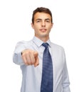 Friendly young buisnessman pointing finger Royalty Free Stock Photo