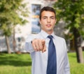 Friendly young buisnessman pointing finger Royalty Free Stock Photo