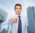 Friendly young buisnessman pointing finger Royalty Free Stock Photo