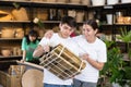 Friendly young couple looking at folded wooden chair in store Royalty Free Stock Photo