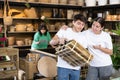 Friendly young couple looking at folded wooden chair in store Royalty Free Stock Photo