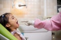 Friendly young dentist examining happy child teeth in dental clinic. Dentistry concept Royalty Free Stock Photo