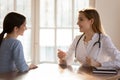 Happy woman enjoying checkup visit with doctor. Royalty Free Stock Photo