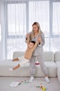 Friendly young playful mother raising child up, imitate fly with small son, leisure Royalty Free Stock Photo