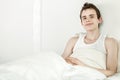 Friendly young teenage boy relaxing in bed Royalty Free Stock Photo