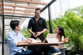 Friendly young waiter talking with the clients outdoors Royalty Free Stock Photo