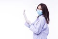 Friendly woman doctor wear coat uniform and medical face mask putting hand in latex or rubber gloves while standing over Royalty Free Stock Photo