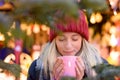 Friendly young woman enjoying a hot beverage