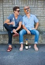 Friends, alcohol and fun with mask at party outdoor, laughing and together. Smile, men in sunglasses and beer for