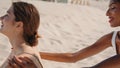 Friends applying suntan cream on beach closeup. Happy girlfriends resting summer