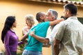 Friends arriving to garden dinner party. Hosts welcoming guests. Royalty Free Stock Photo