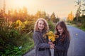 Friends in the autumn day play in the park Royalty Free Stock Photo