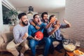 Friends or basketball fans watching basketball game on tv and celebrating victory at home.Friendship, sports and