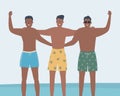 Friends in beach shorts stand against the background of the sea. Three young men in swimming trunks stand together Royalty Free Stock Photo