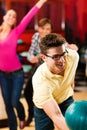 Friends bowling having fun Royalty Free Stock Photo