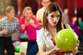 Friends bowling having fun Royalty Free Stock Photo