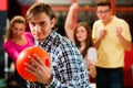 Friends bowling having fun Royalty Free Stock Photo