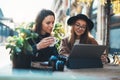 Friends businesswoman using digital tablet. Girls sitting in cafe. Busines communication. Internet laptop technology working